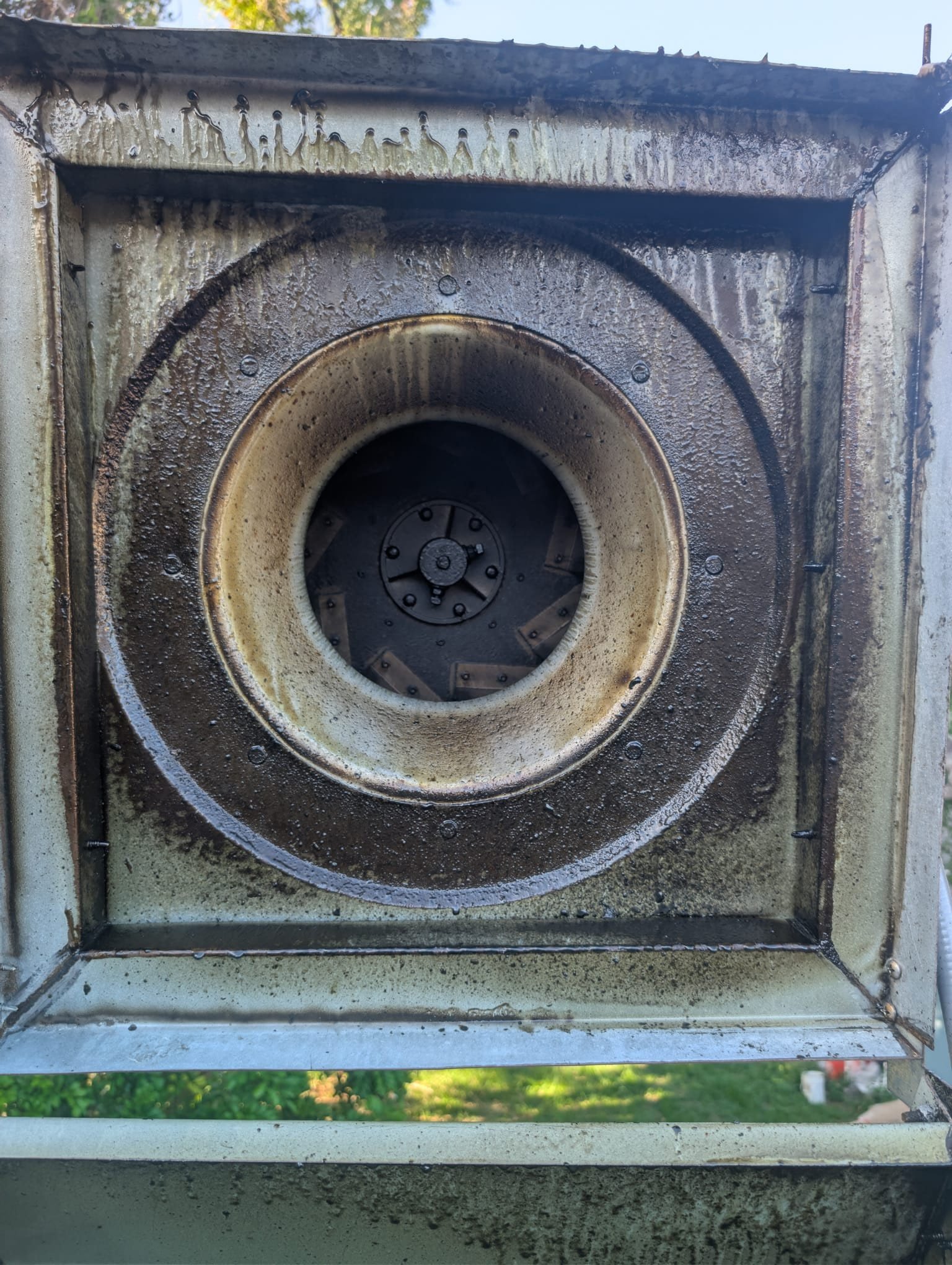 The same exhaust hood plenum before cleaning, coated in thick grease