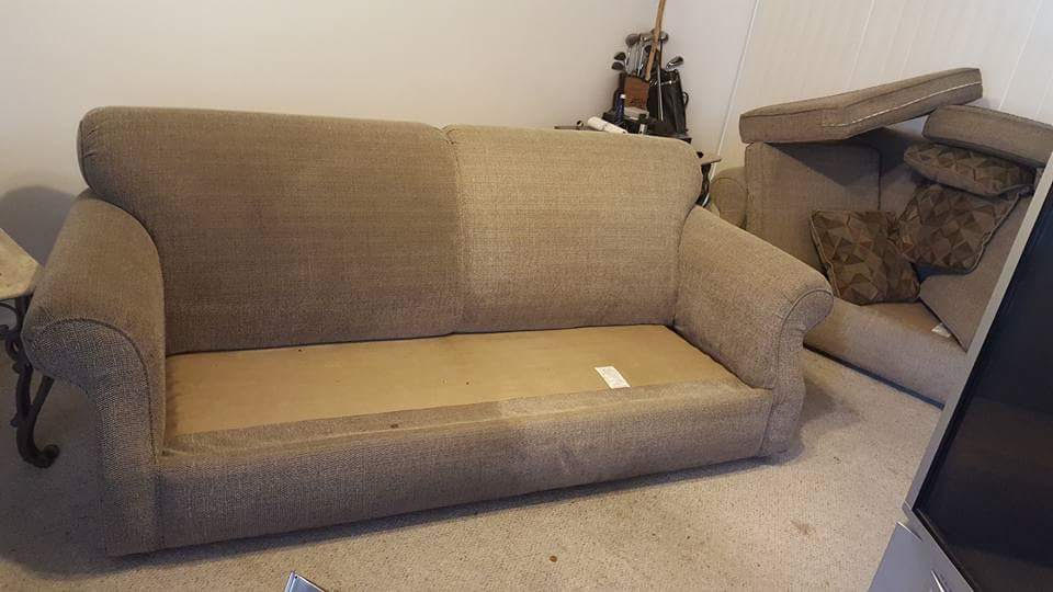 Beige sofa mid-cleaning with cushions removed, showing a clean half beside a dirty half
