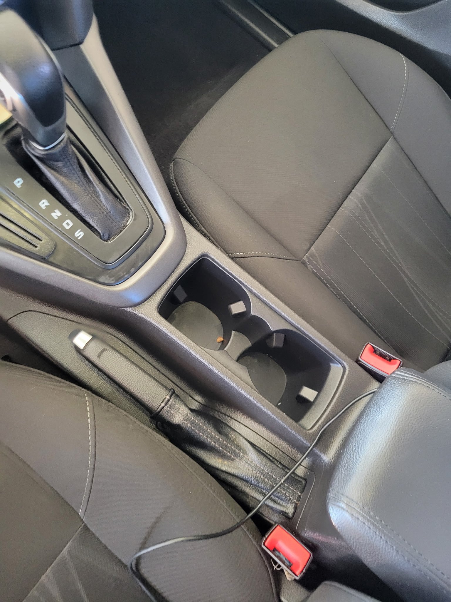 After: clean Ford center console with empty cup holders and a wiped gear shifter area