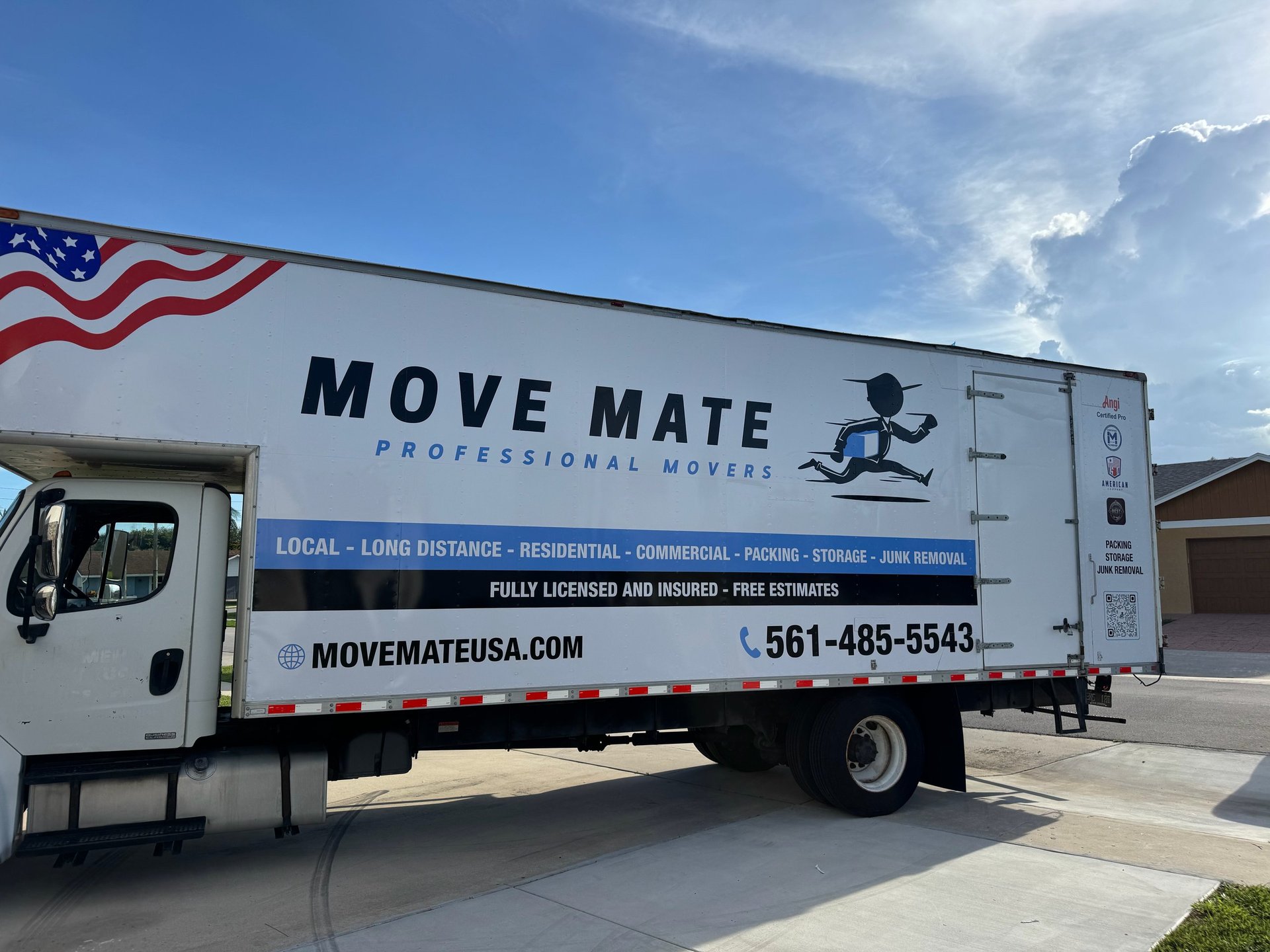 White Move Mate Professional Movers box truck with phone number and website, parked on a street